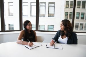 Two businesswomen discussing results during a meeting in a modern office