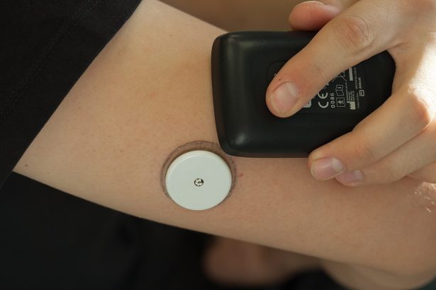 Person scanning a continuous glucose monitor sensor worn on the arm