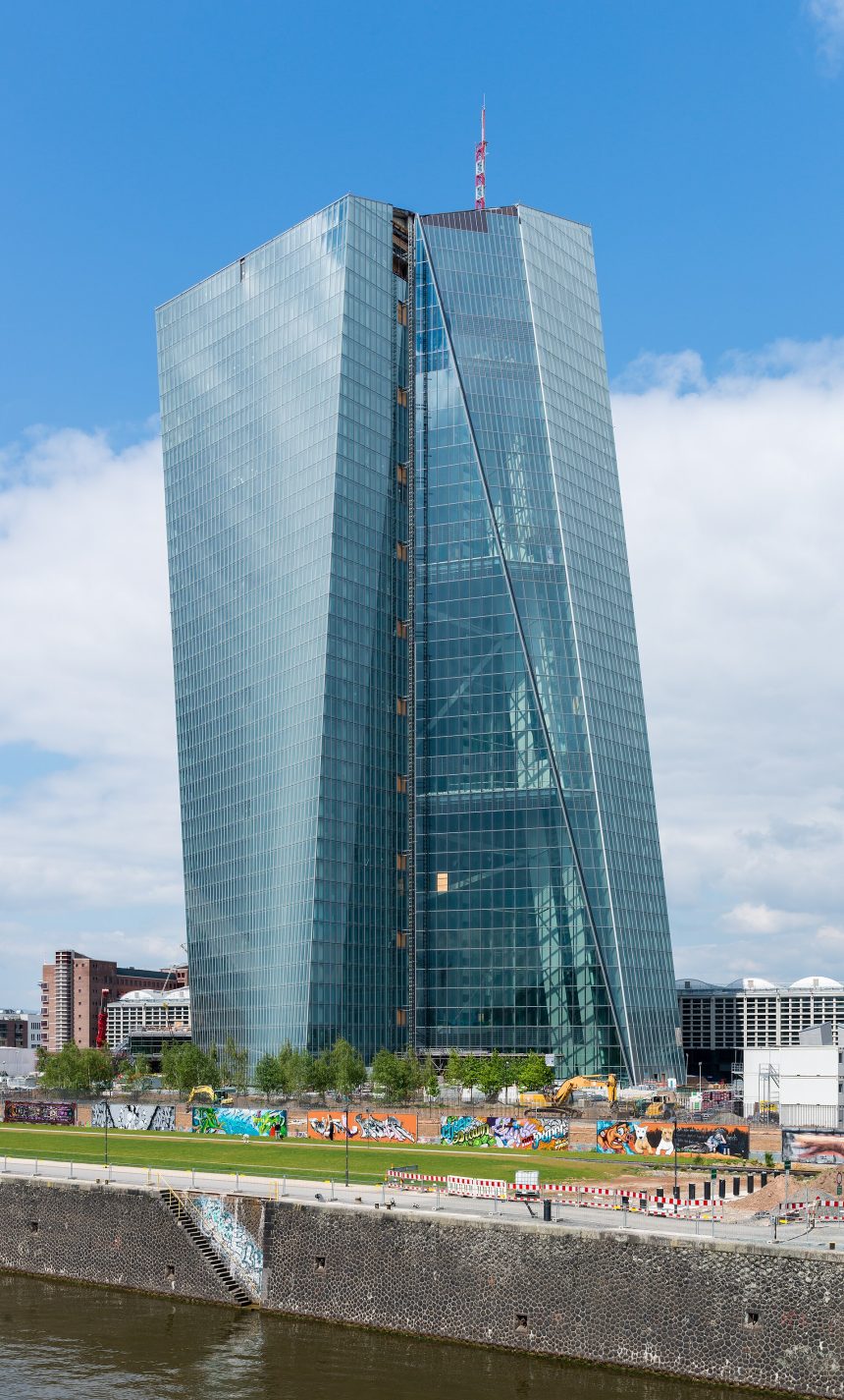 The stone facade of a central bank headquarters building in a financial district.
