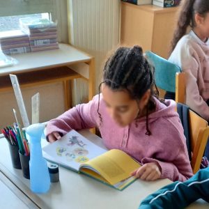 Students in a bright classroom learning without smartphones on their desks