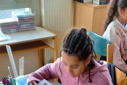 Students in a bright classroom learning without smartphones on their desks