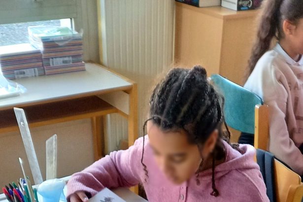 Students in a bright classroom learning without smartphones on their desks